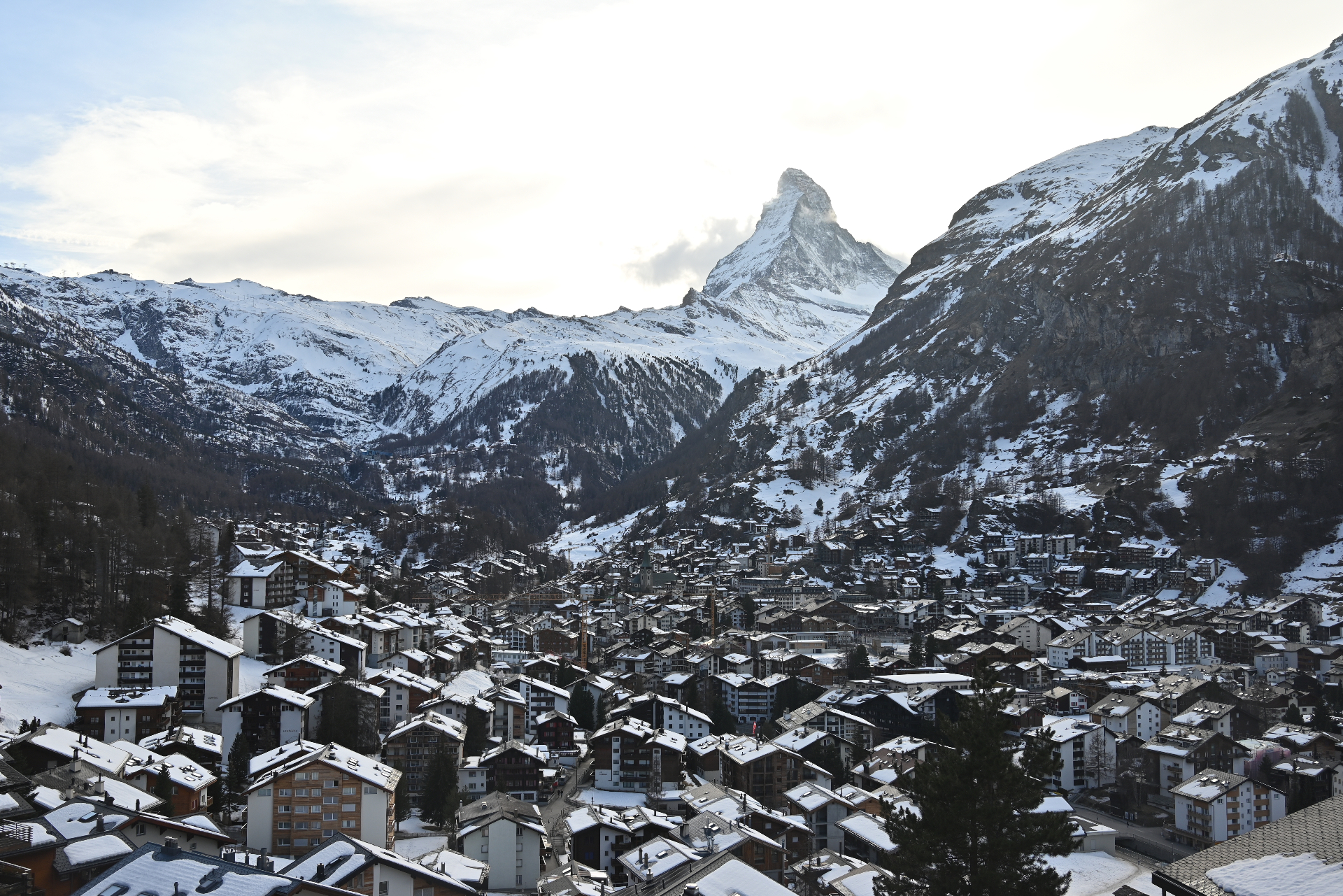 Matterhorn rising above the snow-covered village of Zermatt at dawn